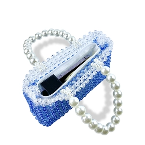 Top view of handmade beaded handbag showing interior space and pearl handles