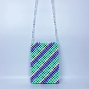 Macro detail of hand-woven acrylic bead crossbody bag in mint green and violet colors