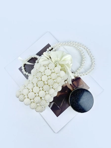 Elegant white pearl beaded bucket bag with drawstring closure and crossbody strap