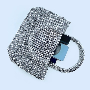 Detail of silver beaded evening tote bag showing capacity for lipstick and makeup