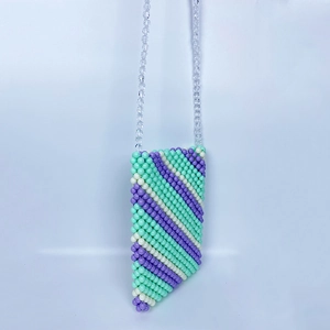 Detail of handcrafted crossbody bag with purple and mint green acrylic beads weaving
