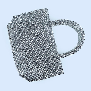 Detailed view of silver beaded evening handbag with handmade woven metallic mesh texture