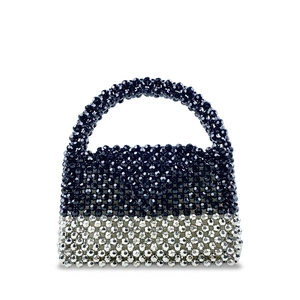 Macro detail of hand-beaded black and silver contrast geometric bead texture on handbag