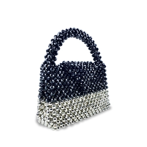 Detail of handmade beaded handbag with black and silver color-blocking design