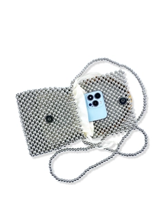 Silver metallic beaded handbag with bamboo handle and interior phone storage view