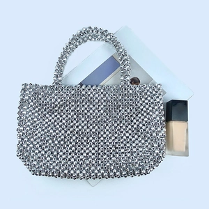 Top view of silver beaded evening handbag with metal texture and fashion accessories