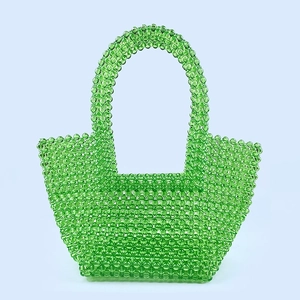 Detail of hand-woven bright green acrylic beaded tote bag with rounded top handles