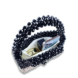 Interior view of beaded handbag showing storage space for phone and makeup items