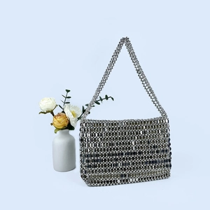 Detail of silver sequin woven shoulder bag with reflective beads and a beaded handle