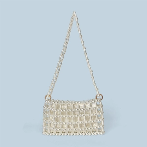 Detailed view of handmade pearl beaded handbag with satin lining and hollow grid weave