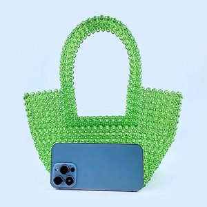 Detailed close-up of handmade green transparent acrylic beaded tote bag with a sleek handle