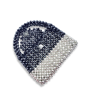 Detail of beaded handbag showing black and silver beads with magnetic closure