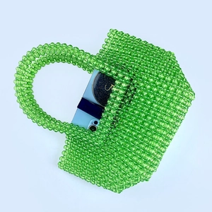 Top view of green acrylic beaded tote bag showing storage capacity for a smartphone
