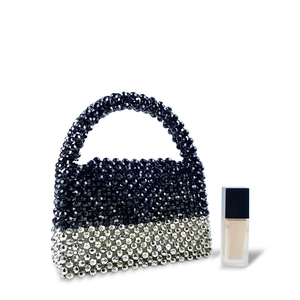 Detail of handmade beaded handbag with black and silver faceted beads and top handle