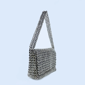 Detail shot of shiny silver metallic beaded shoulder bag with intricate woven texture