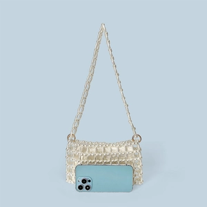 Detail of beaded pearl handbag with gold metal rings and light blue satin lining