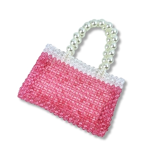 Detailed close-up of handmade pink beaded mini handbag with elegant pearl handle