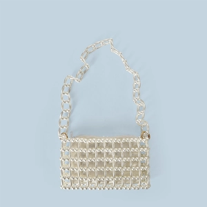 Detail of handmade white pearl beaded bag with hollow grid texture and satin lining