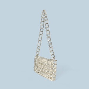 Detail of handmade cream pearl beaded handbag with satin lining and woven mesh pattern
