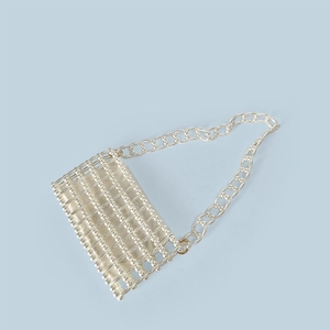 Detail of handmade beaded pearl handbag with white satin lining and shoulder strap