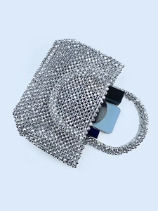 Elegant silver beaded evening handbag with ring handles showing phone and lipstick storage
