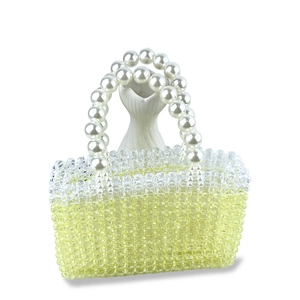 Detail of handmade beaded handbag with yellow gradient beads and pearl beaded handle