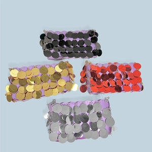 Detailed flat lay of sequin handbags in black gold red and silver with metallic luster