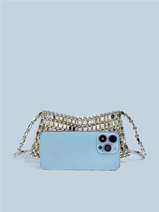 Silver sequin beaded crossbody bag with chain strap shown next to a smartphone