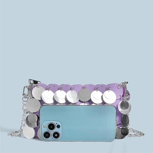 Detailed view of shimmering purple sequins and silver metallic discs on chain bag