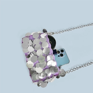 Detail of purple sequin chain bag showing internal capacity for phone and cosmetics