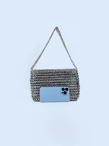 Silver metallic beaded woven flap shoulder bag shown with smartphone for size reference