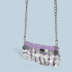 Detailed view of shimmering purple sequins and silver chain on a trendy Y2K party bag