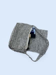 Handmade silver beaded crossbody bag with woven metal beads showing interior storage capacity