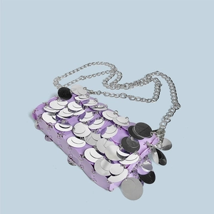Detail of lavender sequin bag with silver accents and long metal chain strap
