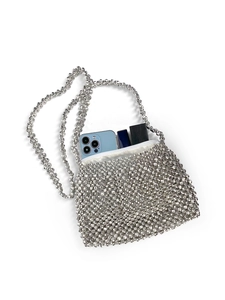 Macro detail of hand-woven silver beaded handbag with zipper and internal lining