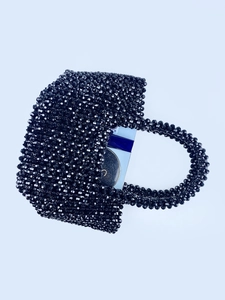 Handmade black beaded tote bag showing storage capacity for phone and cosmetics