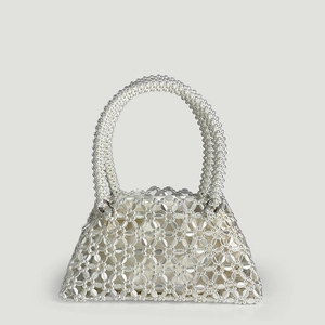 Close-up of white handmade beaded tote bag with pearl-like texture and satin lining detail