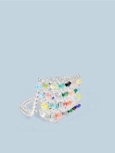 Mini handmade beaded handbag with colorful heart charms on a clean blue background