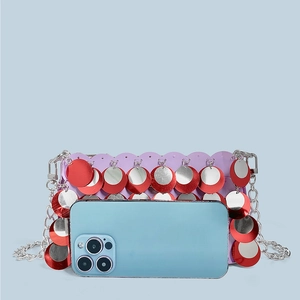 Purple sequin bag with silver chain strap shown next to a smartphone for size reference