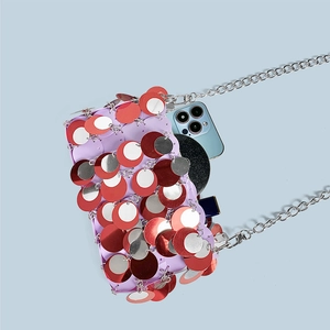 Detail view of colorful sequin chain bag showing internal capacity with essentials