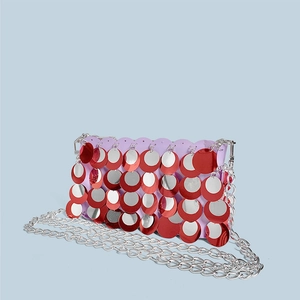 Close-up of sparkling red and silver sequins on a handmade lavender chain shoulder bag
