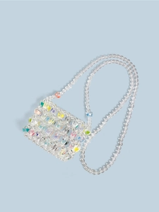 Detailed close-up of handmade transparent beaded crossbody bag with colorful heart beads