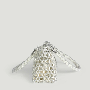 Detailed macro view of retro handmade white beaded tote bag with faux pearls and inner pouch
