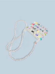 Macro view of hand-woven colorful beaded mini crossbody bag with clear heart textures