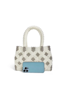 Close-up of handmade beaded handbag featuring silver diamond patterns and pearl texture