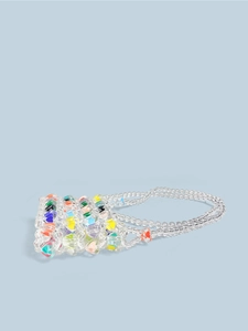 Detail of handmade beaded mini bag with transparent beads and colorful heart accents