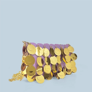 Close-up of sparkling gold sequins and metal chain strap on a purple handmade evening bag