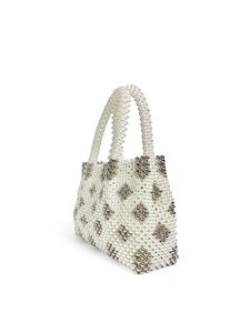 Detailed view of handmade beaded handbag with geometric floral pattern and pearl handle
