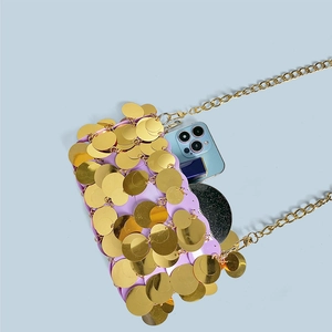 Detail showing the interior capacity of the purple and gold sequin chain shoulder bag