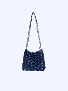 Detail of blue chainmail shoulder bag with metallic sequins and silver chain strap
